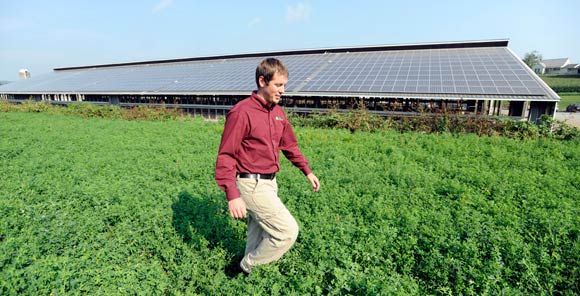 Paradise Energy Solutions CEO Tim Beiler inspects an installation of solar panels at a the Hope Valley dairy Farm